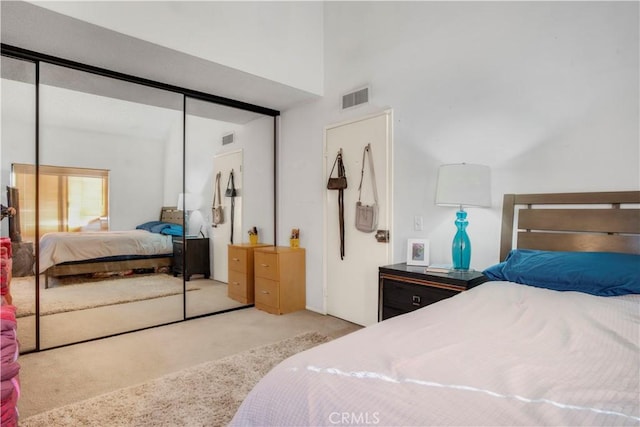 bedroom with a closet, carpet flooring, and visible vents