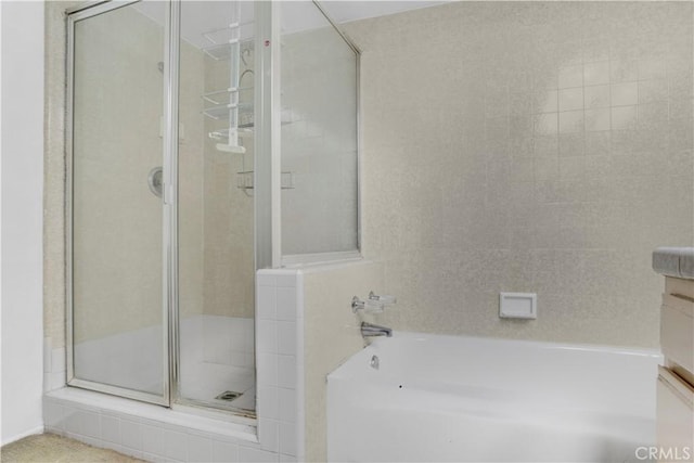 bathroom with vanity, a shower stall, and a bathing tub