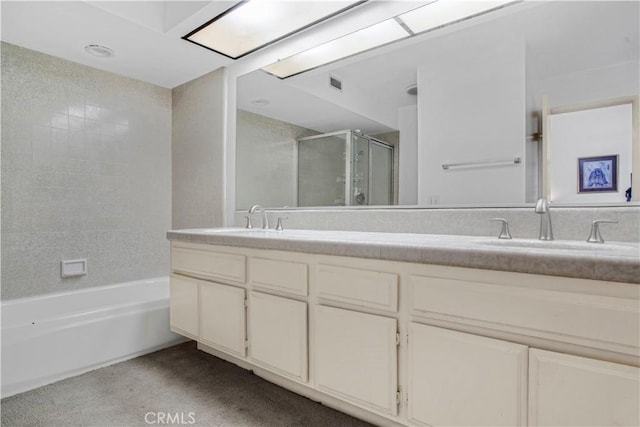 bathroom with a shower with shower door, a sink, a bathing tub, and double vanity