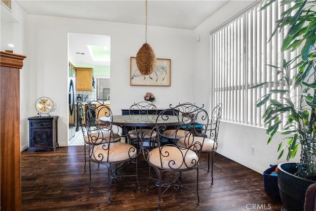 dining room with dark wood finished floors and baseboards