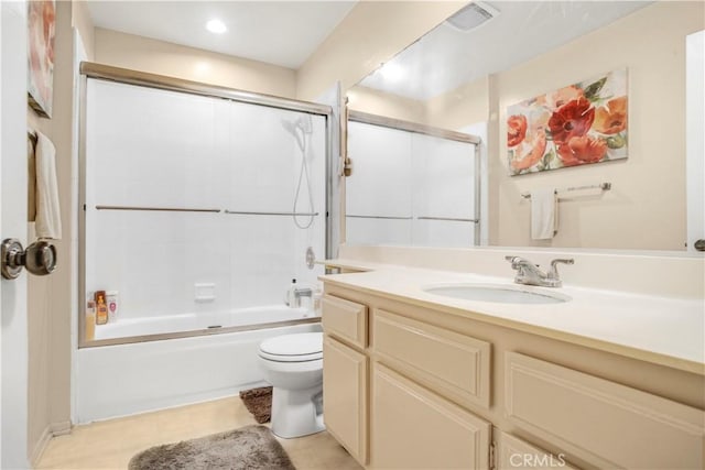 full bathroom featuring visible vents, shower / bath combination with glass door, vanity, and toilet