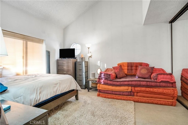 bedroom featuring vaulted ceiling, multiple windows, carpet, and a textured ceiling