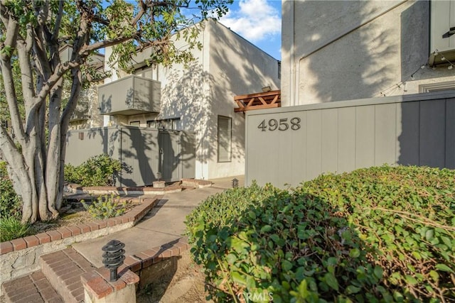 exterior space with fence and stucco siding