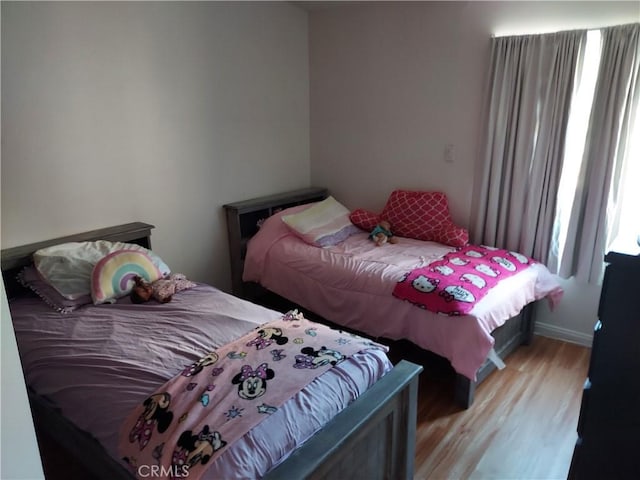 bedroom featuring light wood-style floors