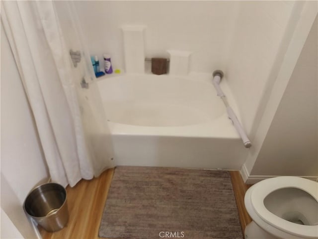 bathroom featuring toilet and wood finished floors