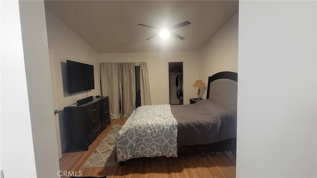 bedroom with vaulted ceiling, wood finished floors, and a ceiling fan