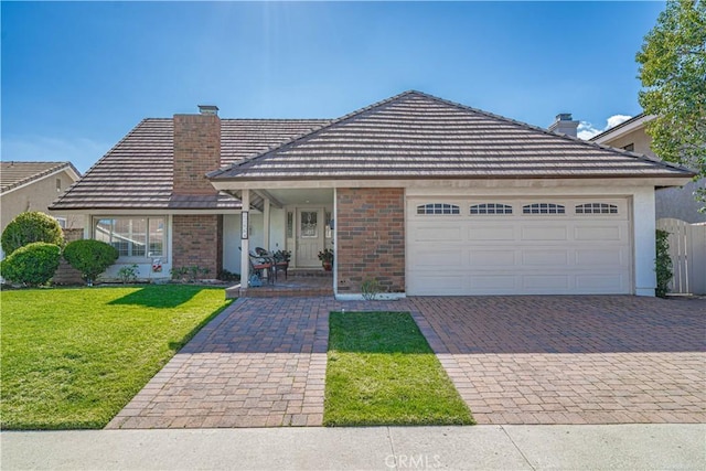 view of front of property with a garage and a front lawn