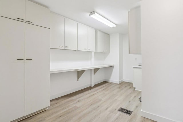 laundry area featuring light wood-type flooring