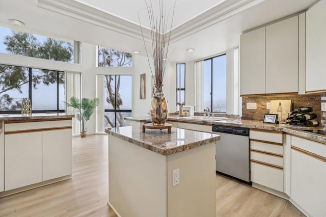 kitchen featuring white cabinetry, crown molding, stainless steel dishwasher, and a kitchen island