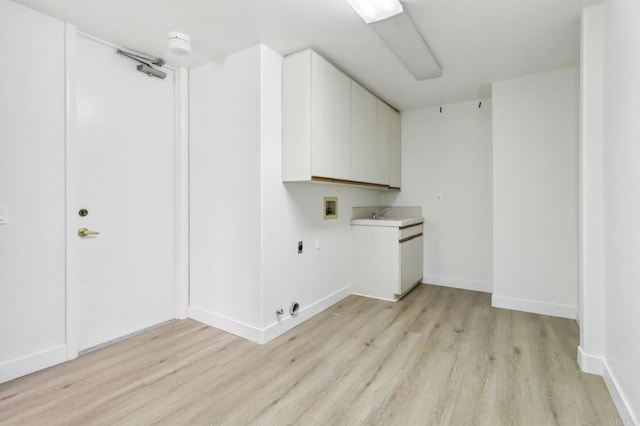 laundry area with cabinets, washer hookup, hookup for an electric dryer, and light hardwood / wood-style floors