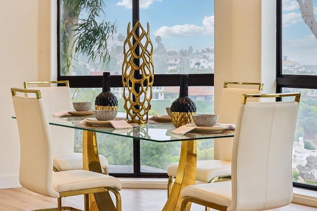 dining space with wood-type flooring