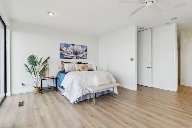 bedroom with ceiling fan and light hardwood / wood-style floors