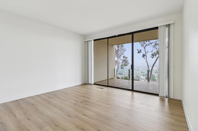 spare room featuring light hardwood / wood-style floors