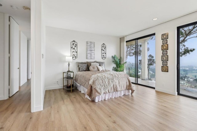 bedroom with light hardwood / wood-style flooring and access to outside