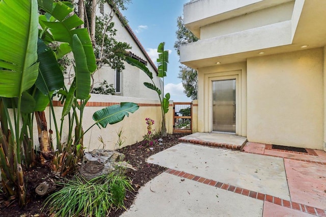 entrance to property with a patio