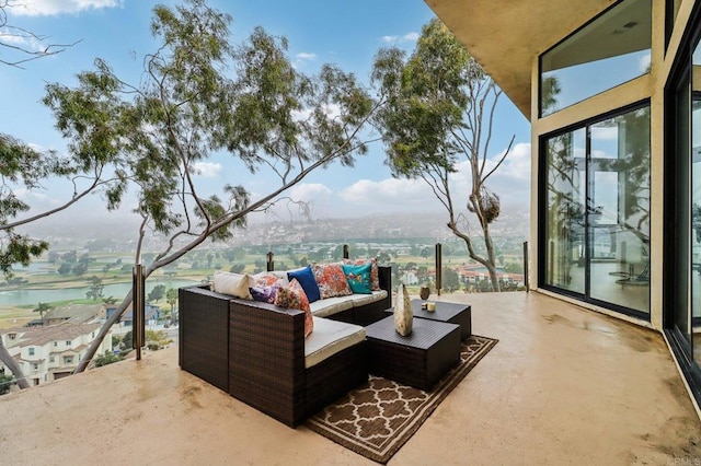 view of patio / terrace featuring outdoor lounge area, a balcony, and a water view