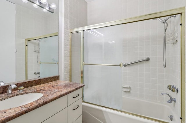 bathroom featuring enclosed tub / shower combo and vanity