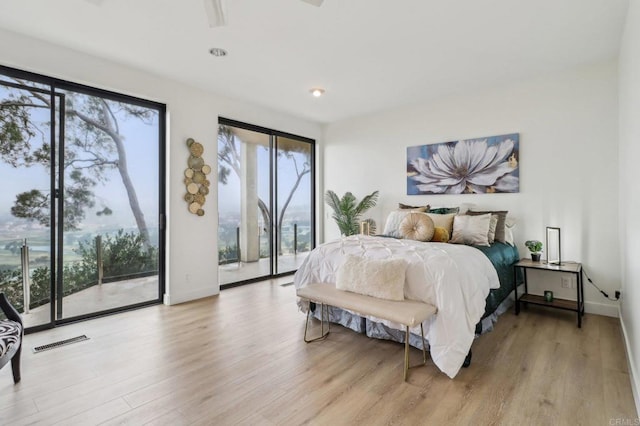 bedroom featuring access to exterior and light hardwood / wood-style flooring