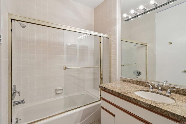 bathroom with vanity and bath / shower combo with glass door