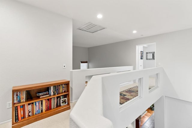 interior space featuring an upstairs landing and recessed lighting