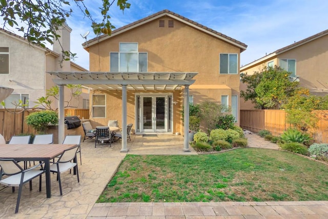 back of property with a fenced backyard, french doors, a pergola, and stucco siding