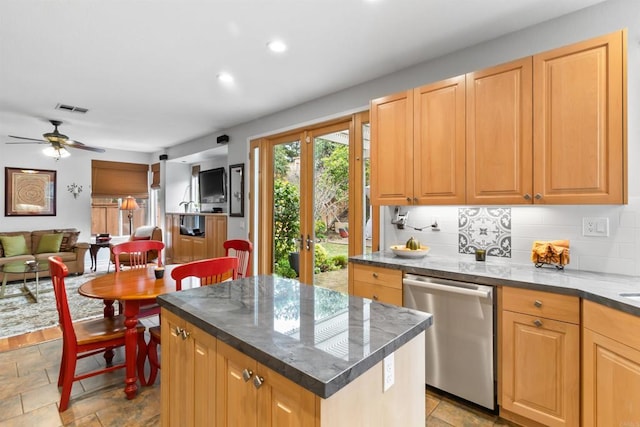 kitchen with a center island, visible vents, backsplash, stainless steel dishwasher, and open floor plan