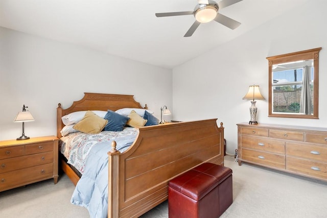 bedroom featuring vaulted ceiling, a ceiling fan, and light colored carpet