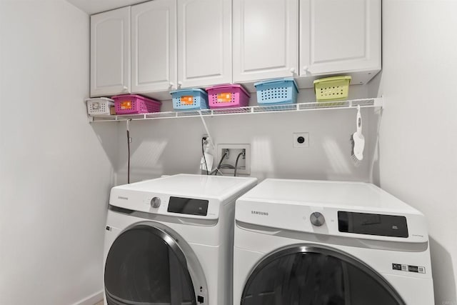 laundry area featuring cabinet space and washer and clothes dryer