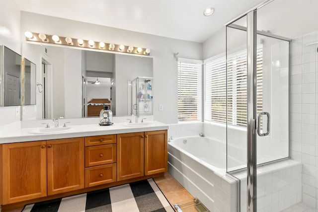 full bathroom with a stall shower, tile patterned floors, a sink, and a bath