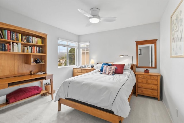 bedroom with light colored carpet, ceiling fan, and baseboards