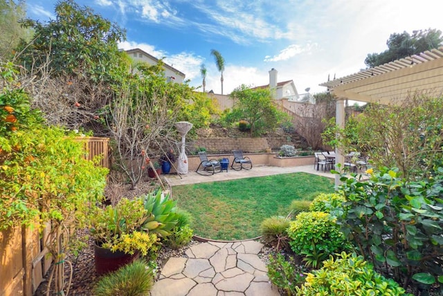 view of yard with a patio area, a fenced backyard, and a pergola