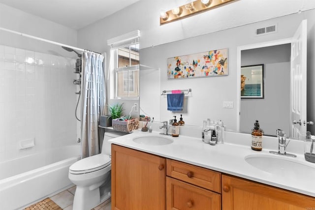 bathroom featuring visible vents, a sink, toilet, and double vanity