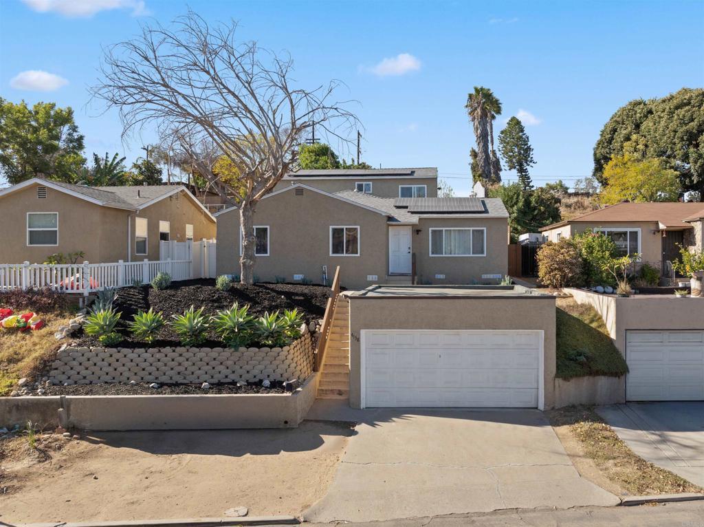 view of front of home featuring a garage and solar panels