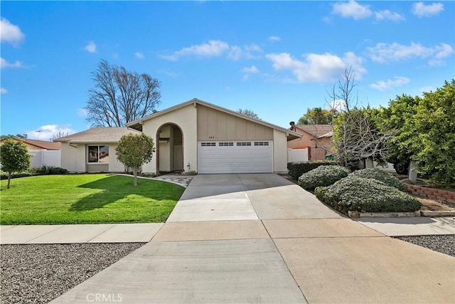 ranch-style house featuring a garage and a front lawn