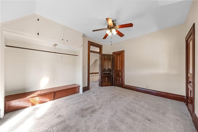 unfurnished bedroom with light colored carpet and ceiling fan