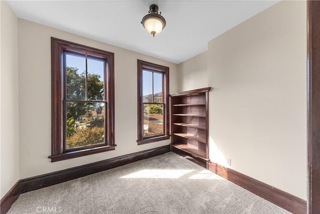 empty room featuring dark colored carpet