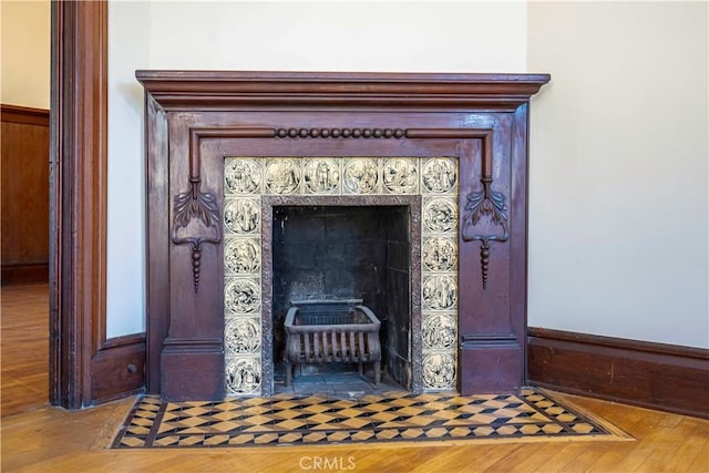 details with hardwood / wood-style flooring and a fireplace