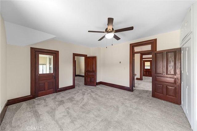 unfurnished bedroom with light carpet and ceiling fan