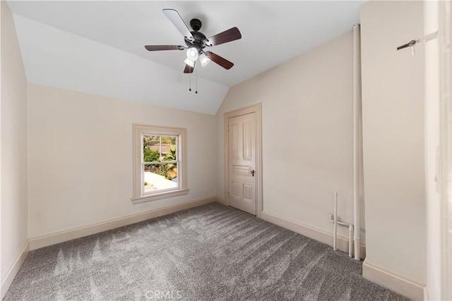 unfurnished bedroom featuring lofted ceiling, ceiling fan, and carpet flooring