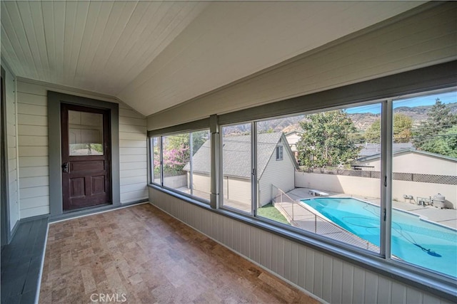 unfurnished sunroom with wood ceiling and vaulted ceiling