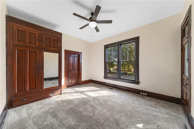 unfurnished bedroom with light carpet and ceiling fan