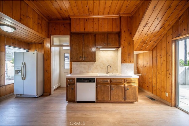 kitchen with dishwasher, sink, white refrigerator with ice dispenser, wood ceiling, and light hardwood / wood-style flooring