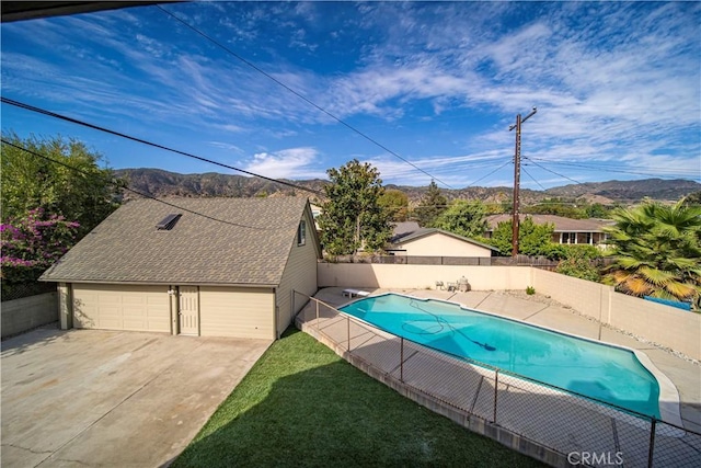 view of swimming pool featuring a diving board and a mountain view