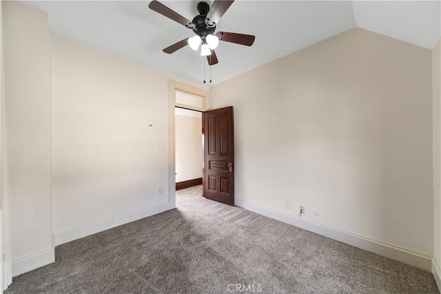 carpeted spare room featuring lofted ceiling and ceiling fan