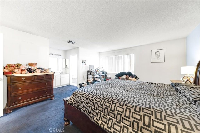 carpeted bedroom with a textured ceiling