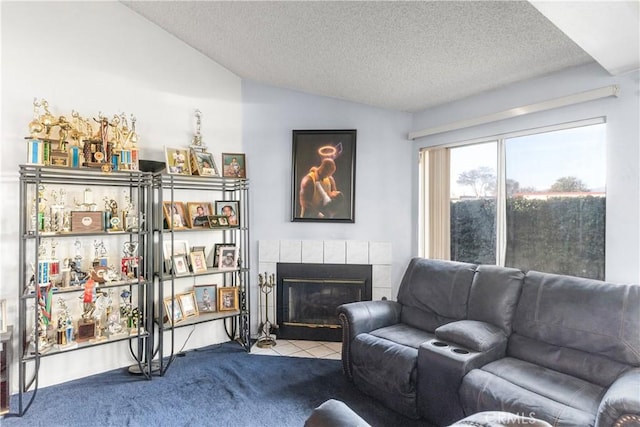 carpeted living room with a tiled fireplace, lofted ceiling, and a textured ceiling