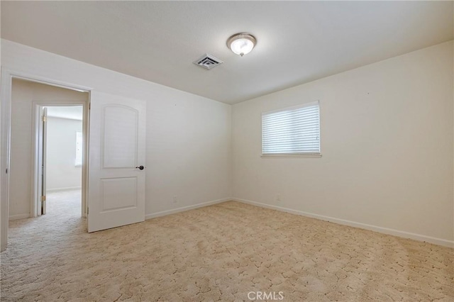 empty room featuring light carpet