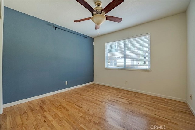 spare room featuring ceiling fan and light hardwood / wood-style floors