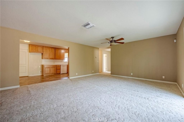 unfurnished living room featuring light colored carpet and ceiling fan