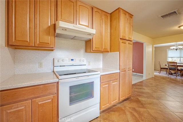 kitchen featuring an inviting chandelier, light tile patterned floors, and white range with electric stovetop